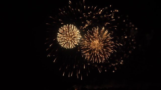 Slow motion fireworks show , red and white spheres inside with smaller sphere