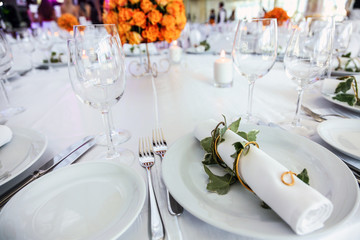 Holiday table setting decorated with flowers and candles.