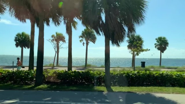 View at Miami's embankment and kate surfers on blue sky background