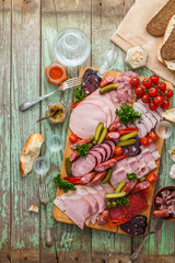 Assorted sausages and smoked meat with pickles, bread and vodka on wooden board, top view copy space - 238145957