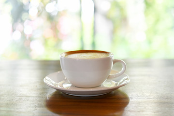 Fototapeta na wymiar Latte coffee cup on wooden table