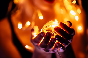 portrait of a girl with a garland on black background