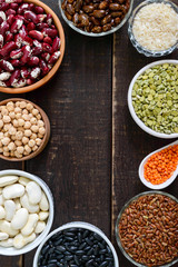 Healthy food dieting nutrition concept, vegan protein and carbohydrate source. Assortment of colorful raw legumes in bowls on a wooden table.