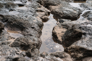 The stony coast of the Atlantic Ocean. Image of the Grand Canaria island surf  (Spain)