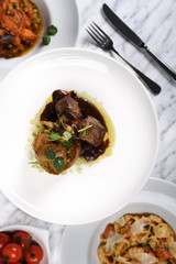 Lamb chops with baked baby potatoes and artichoke sauteed and red wine sauce