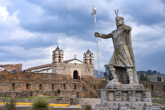 A statue of Inca Pachacutec and Catholic church in the plaza of Vilcashuaman. Ayacucho, Peru