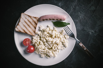 Scrambled egg and sausage on plate