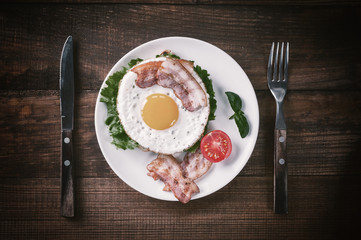 Fried egg and bacon on plate