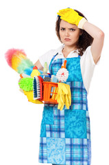 Tired young housewife with yellow gloves and cleaning supplies in box, isolated on white background