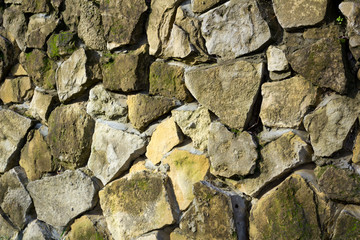 old wall of natural stone covered 