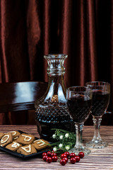 Christmas still life - red wine, sweet cookies and red currants