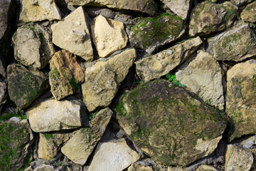 the old wall of natural stone 