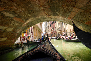 Venice canals in Italy, bridges, tourists and gondoliers in the summer on a sunny day, Venice, Italy June 28, 2011