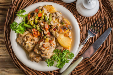 Fillet of chicken legs with stewed vegetables.