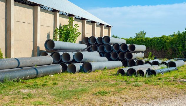 Stacks of blue PVC water pipes  in stack on open storage at an factory