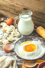 Ingredients and tools for baking and raw homemade italian ravioli, dumplings