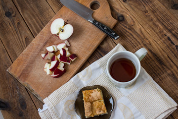 apple pie knife and tea on a wooden background