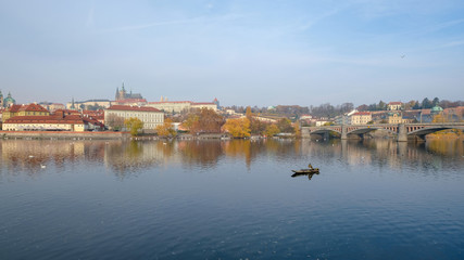 Prague Castle with Vltava river and fisherman view from old town side in autumn season, Czech Republic