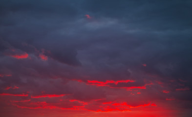 Beautiful bright colorful sky. Picture taken at sunset. Red-orange background with nice paints. Rare sunrise. Natural composition
