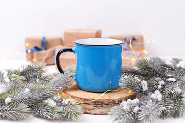 Obraz na płótnie Canvas Blue mug with hot tea, coffee or cocoa on winter holidays background.