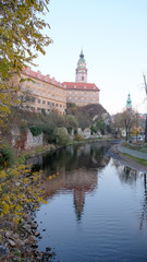 Fototapeta na wymiar cesky krumlov castle tower with refection on vltava river in autumn
