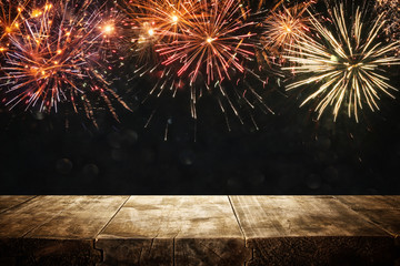 Empty wooden table in front of fireworks background. Product display montage. © tomertu