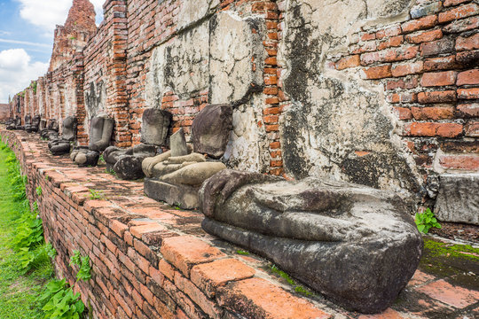 Remains statues of sitting Buddha image at Wat Mahathat. The old Buddhism ruins in Ayutthaya, Thailand, Southeast Asia.