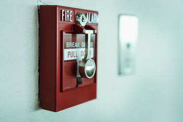 Manual fire alarm box at cement wall in the building.selective focus.