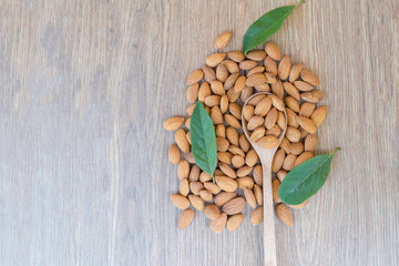 Almond nut on wood background.