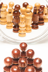 Chess pieces facing mirror. Business and motivational concepts. High resolution image.
