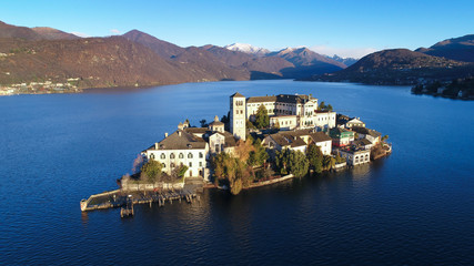 Aerial view of Lake Orta (Piedmont, Italy) with the San Giulio island at dawn on a sunny winter day.
