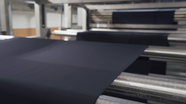 Spinning factory, production of fabrics, vinyl rolling on production line, automated process on light industry.