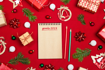 Notebook with a list of goals for the year and Christmas composition of gifts  and decoration on...