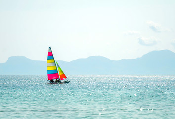 Fototapeta premium Colorful catamaran sailing in the sea