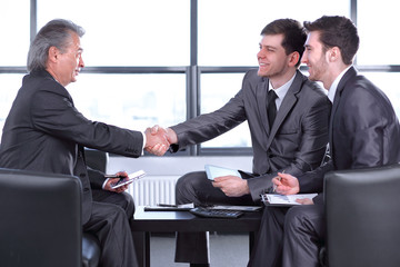 boss with a clipboard , sitting in an office. photo with copy space