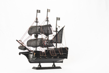 Fototapeta premium Black pirate boat model on white background. High resolution image.