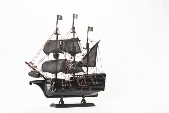 Black pirate boat model on white background. High resolution image.