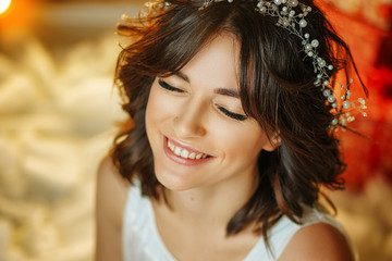 portrait of a beautiful young woman on the background of lights, beautiful make-up and styling