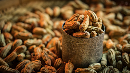 Peanuts in a cup are placed on peanuts.