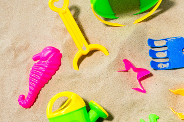 Fototapeta na wymiar childhood and summer concept - close up of sand toys kit on beach