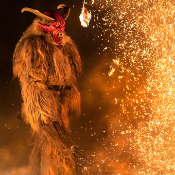 The Krampus masks in an exhibition in the night in Tarvisio, Italy