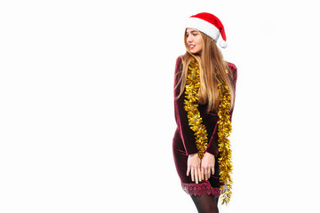 Happy woman in santa hat and dress celebrating new year looking at empty space on white background.