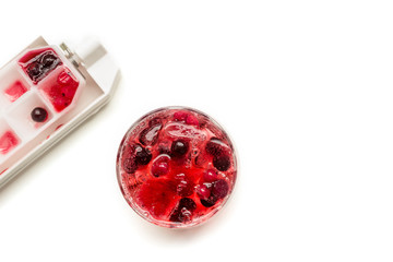Cocktail of berries frozen in ice cubes (raspberries, blackberries , red and black currants) ....