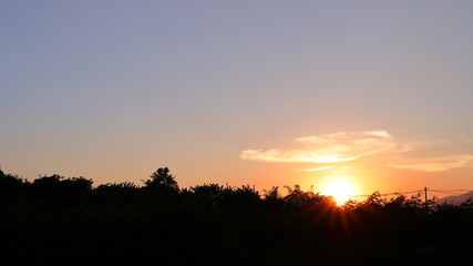 Fototapeta premium orange sun light on beautiful sunset clear blue sky background