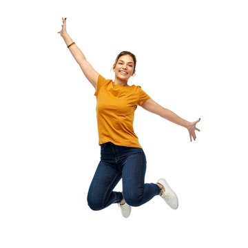 motion, freedom and people concept - happy young woman or teenage girl jumping over white background