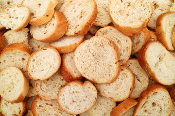 Texture of slices of light white wheat bread with splashes of dried onion
