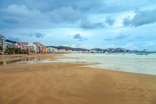 Sandy beach after rain in a resort town of Cullera, near Valencia in Spain.