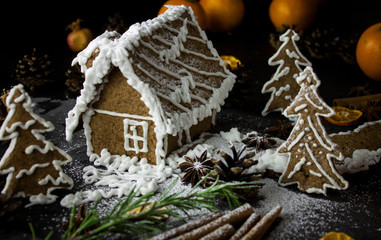 Gingerbread house on black night background, ginger cookies christmas dark photo