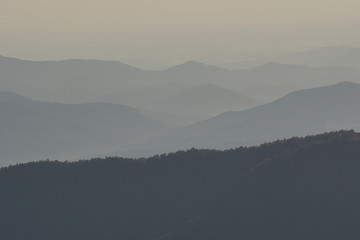 rolling mountain landscape with fall color foliage and forest and blue haze in the Blue Ridge mountains of North Carolina