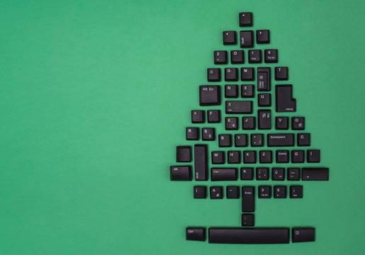 Christmas tree made of black computer keys with space for text